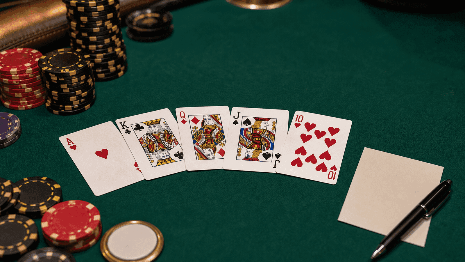 Five-card PLO tournament hand with live chips, five hole cards, and a preflop decision sheet on a poker table.